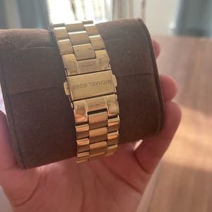 Gold Micheal Kors Watch with Pink Face. Some wear under wrist.
